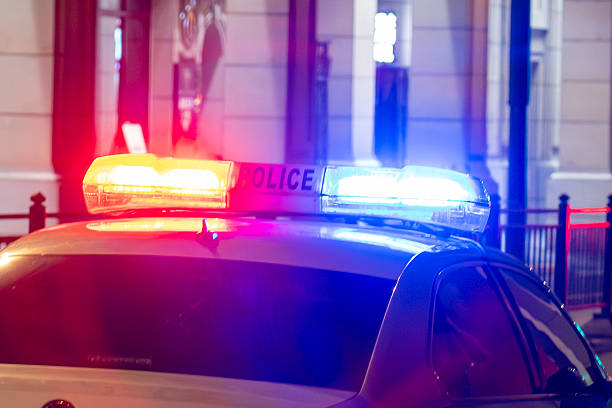 istock Police Car Lights Flashing at Night - Emergency Response Scene 2239044389