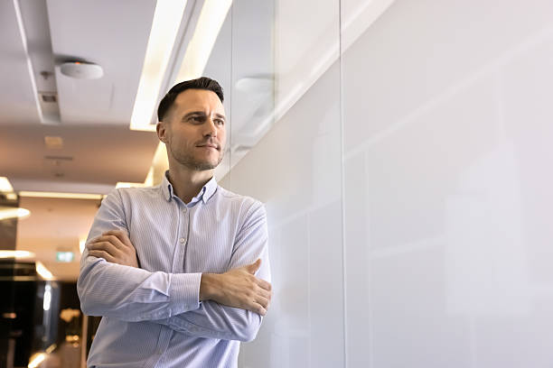 istock Serious thoughtful ambitious Hispanic businessman standing in office hall 2239046623