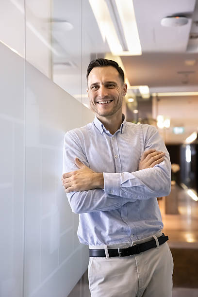 istock Positive confident professional executive man posing in office corridor 2239046783