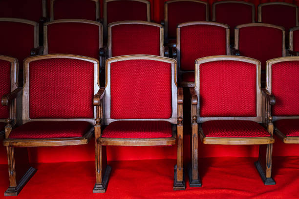 istock Rows of vintage red chairs arranged neatly in an empty auditorium setting 2239046967