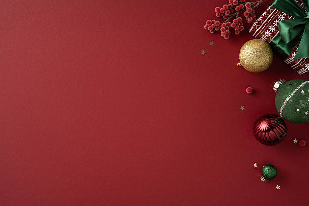 istock Bright red backdrop with festive ornaments, berries, and wrapped presents creates a warm holiday mood for Christmas and New Year greetings, celebrations, and seasonal decoration ideas 2239048223