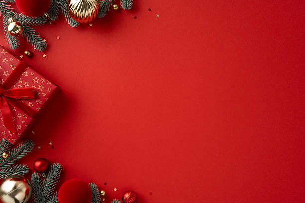 istock Vibrant red background with a wrapped gift, ornaments, and frosted pine branches captures a festive mood for Christmas and New Year greetings and celebration 2239048244