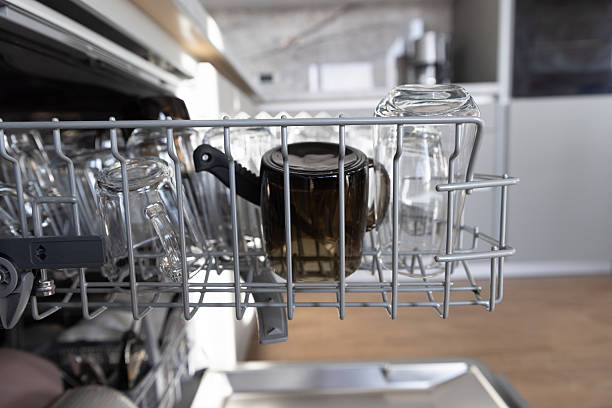 istock Dishwasher Rack With Glasses And Mug In Modern Kitchen For Cleanliness And Organization 2239049534