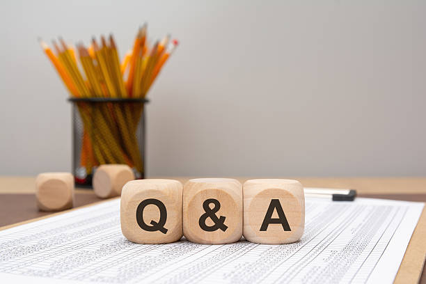 istock Wooden cubes spelling Q and A on financial document 2239051903