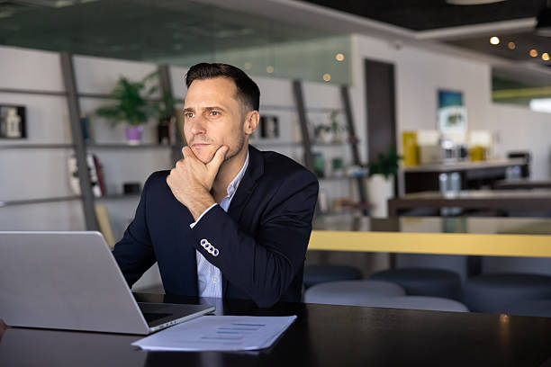 istock Thoughtful serious Latin company executive man working at laptop 2239052605