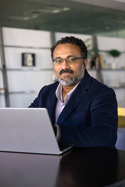 istock Positive successful senior Indian business executive man working at computer 2239053452