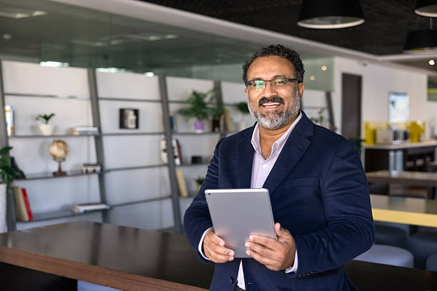 istock Happy mature Indian CEO man posing in office co-working hall 2239056158