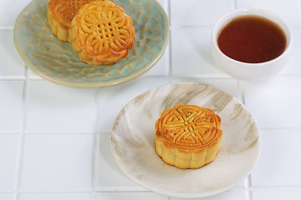 istock Chinese Mooncake Served with Hot Tea on White Table 2239064675