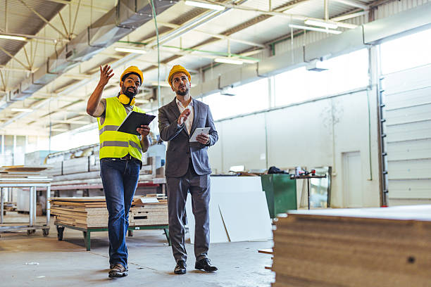 istock Two Professionals Discussing Plans in a Newly Constructed Industrial Workshop Space 2239068111