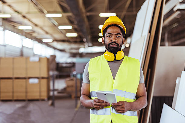 istock Industrial Worker in Reflective Vest with Tablet in a Warehouse 2239068160