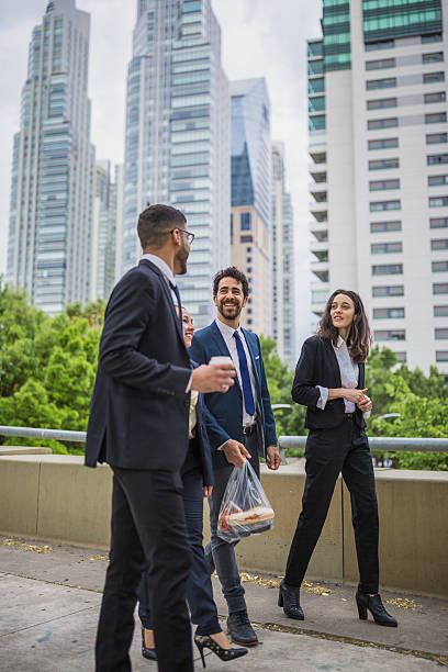 istock Business Professionals Walking Outside with Cityscape View 2239068554