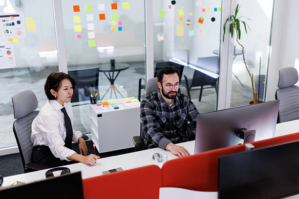 istock Business professionals collaborate in a modern office space during a brainstorming session on project ideas in the afternoon 2239070397