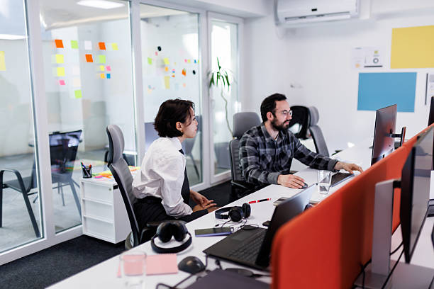 istock Business professionals discuss project details in a modern office with colorful sticky notes during work hours 2239070405