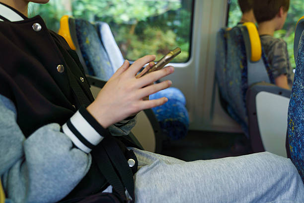 istock Children Using Smartphones On  Public Transport 2239082780