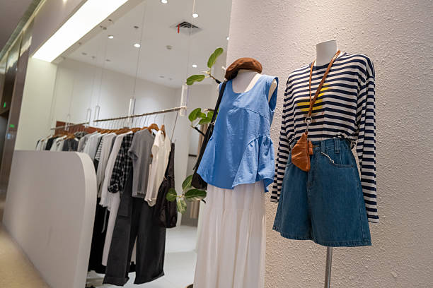 Showcase with autumn clothes of different colors. Jackets and sweaters dressed as mannequins attract buyers, clothing market