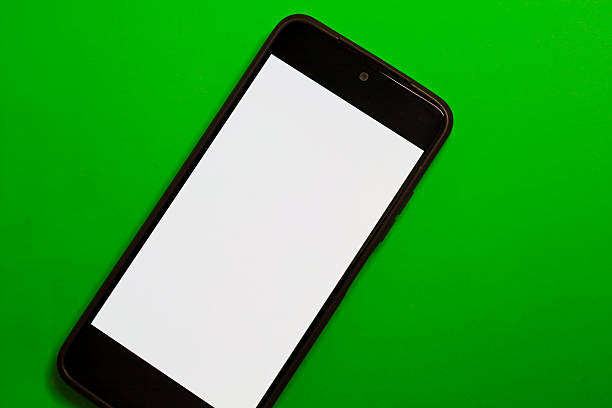 istock A smartphone with a clean white screen is positioned diagonally on a vivid green background, creating a strong color contrast. This digital mockup is ideal for presenting a mobile interface, applications, or web pages using the copy space provided. 2239093166