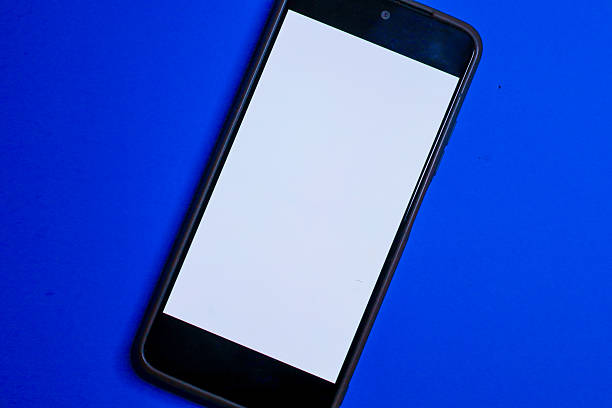 istock A smartphone with a clean white screen is positioned diagonally on a vivid blue background, leaving copy space for design. This digital mockup is ideal for presenting a mobile interface, web pages, or applications in a modern style. 2239093169