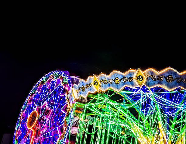 istock Colorful Neon Ferris Wheel at Night Carnival 2239099299
