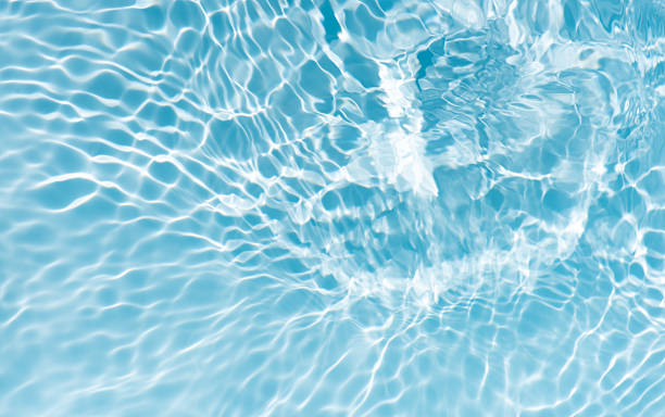 istock Blue water with ripples on the surface. Defocus blurred transparent blue colored clear calm water surface texture with splashes and bubbles. Water waves with shining pattern texture background. 2239100910