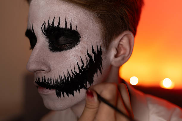 istock man with dramatic black makeup and black and white face paint, gazing intensely 2239107803