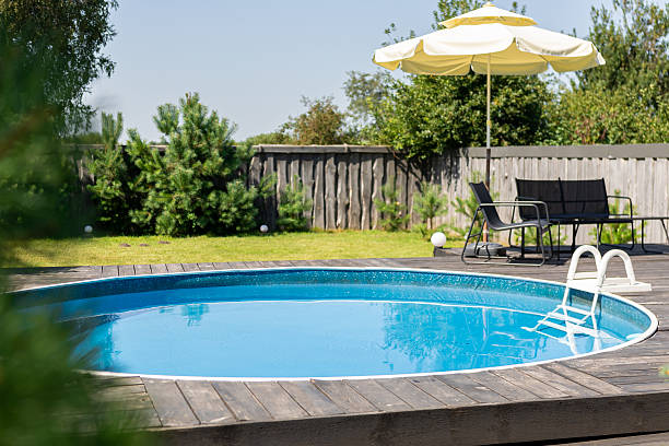 istock Luxurious backyard with modern blue swimming pool 2239108213