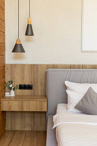 istock Modern bedroom with sleek bed wooden paneling 2239108215