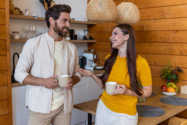istock Young couple at the kitchen having good time and a nice chat 2239108454