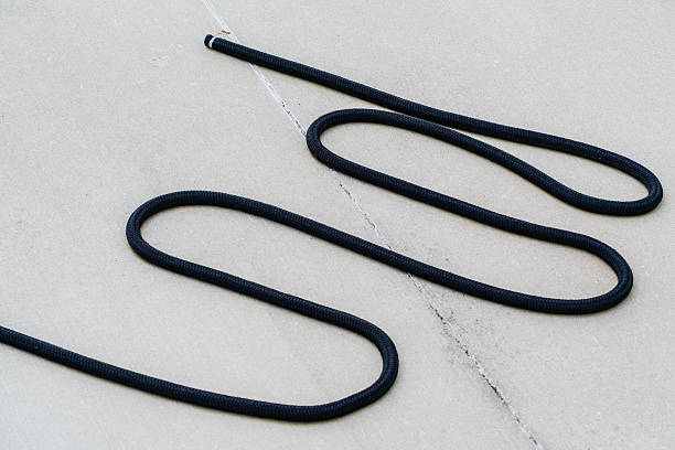 istock Simple black boat rope on clean white surface. 2239108787