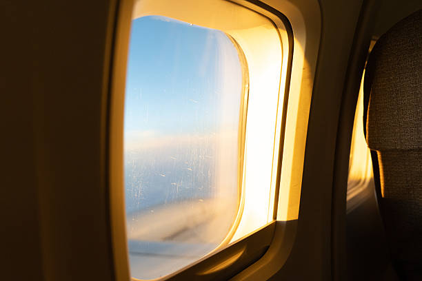 istock Golden sunlight fills the airplane window 2239110200