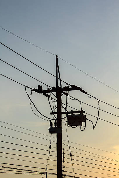 istock High voltage electric power lines and pylons against a blue sky 2239110658