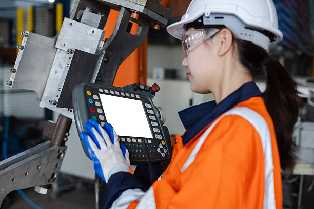 istock Remote control automation robotics with white screen. Empty space to put photo or video of robot arm driver. woman working at factory innovation automation. Mock up white space. 2239113332