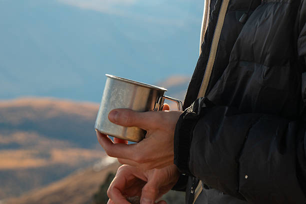 Holding a Mug in the Mountains