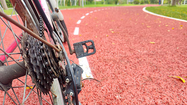 Bicycle rear wheel and pedal on a red track