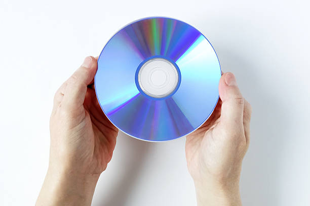 istock A Caucasian woman holds a CD in her hands. White background, top view. 2239116737