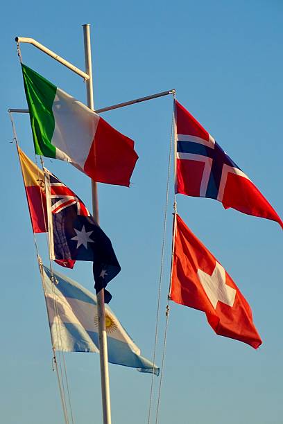 istock Group of flags on a flagpole with a blue sky background 2239116761
