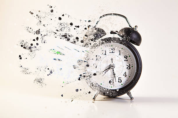 istock Alarm clock with explosion of confetti on a white background. 2239118701