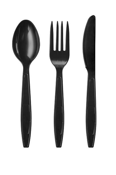 istock Disposable recycled plastic spoons, fork and knife on a white 2239118803