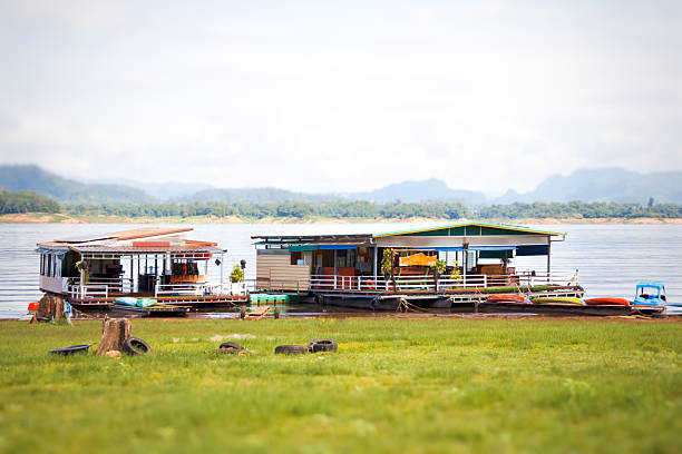 The house floats in a quiet lake.
