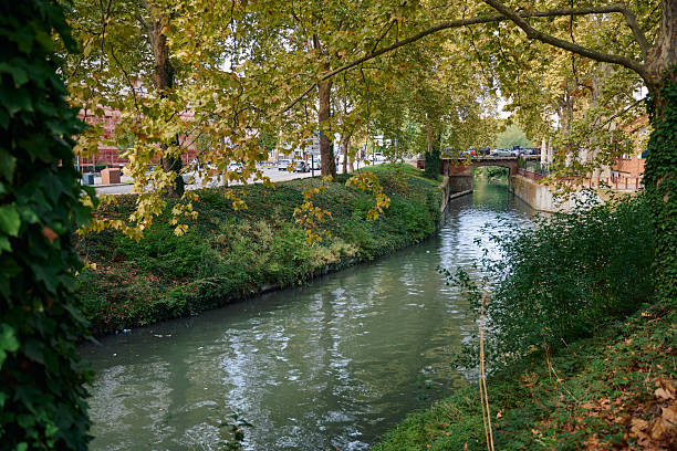 istock Toulouse canal flowing under bridge with autumn trees 2239120116