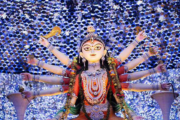Hand holding mobile phone and taking photos of Goddess Durga idol at a pandal. Durga Puja memories of 2019 is the biggest religious festival of Hinduism and Bengali Community.