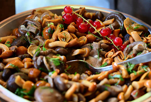 salted mushrooms chanterelles served with fresh berries and vegetables