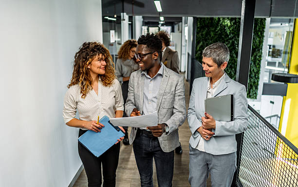 Business colleagues walking and discussing in modern office