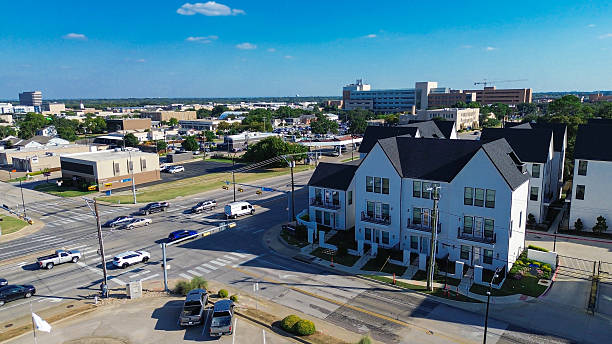 istock Cooper and Main Street intersection in downtown Arlington, Texas during peak hour. New development townhomes, retail buildings, and parking lots form a dense, transit-integrated urban corridor 2239127403