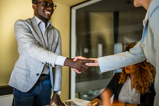 istock Diverse business professionals shaking hands in office 2239128371