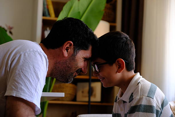 father and son are laughing