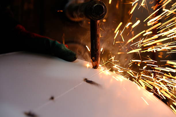 a master who welds sheet metal with spot welding