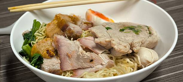 istock Chinese-style noodle soup on a wooden table 2239131068