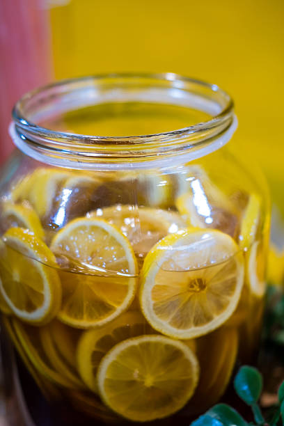 Honey and lemon slices in a jar, showcasing a natural and healthy remedy