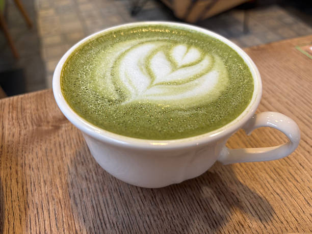 istock Matcha latte with decorative foam on a wooden table 2239131759