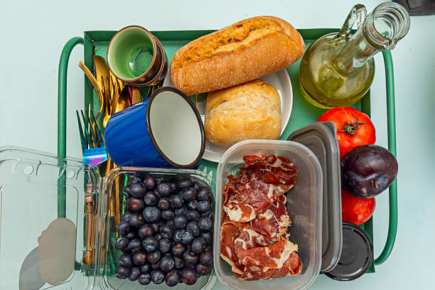 istock A tray filled with cutlery, fresh fruit, Spanish ham, bread, and oil 2239133242